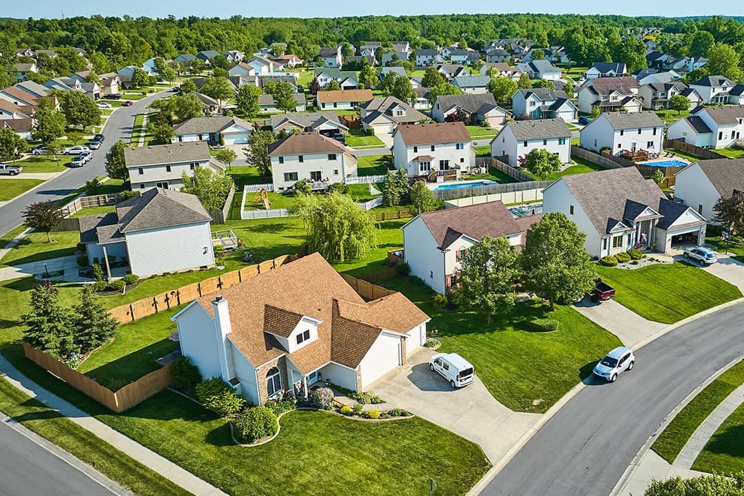 Aerial view of a residential area with two story houses.