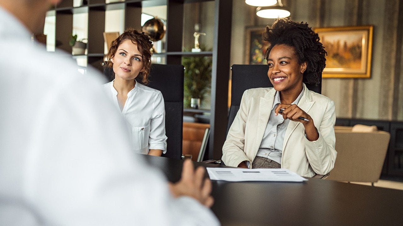 Business managers collaborating during a meeting with a prospective partner. 