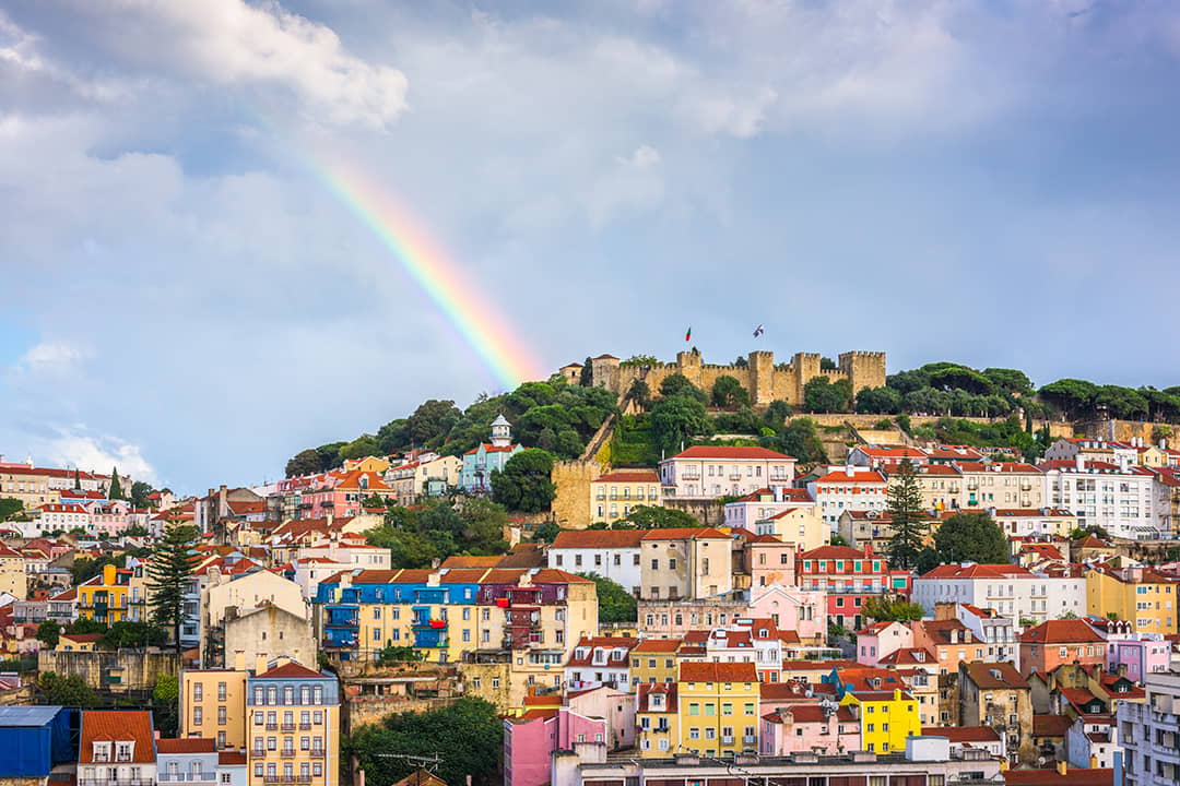 A rainbow seen over the Sao Jorge Castle and Lisbon skyline in Portugal.