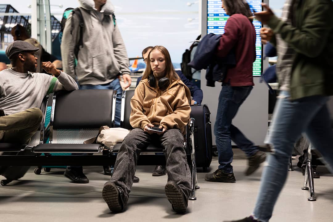 An upset young woman at the airport after a delayed flight.