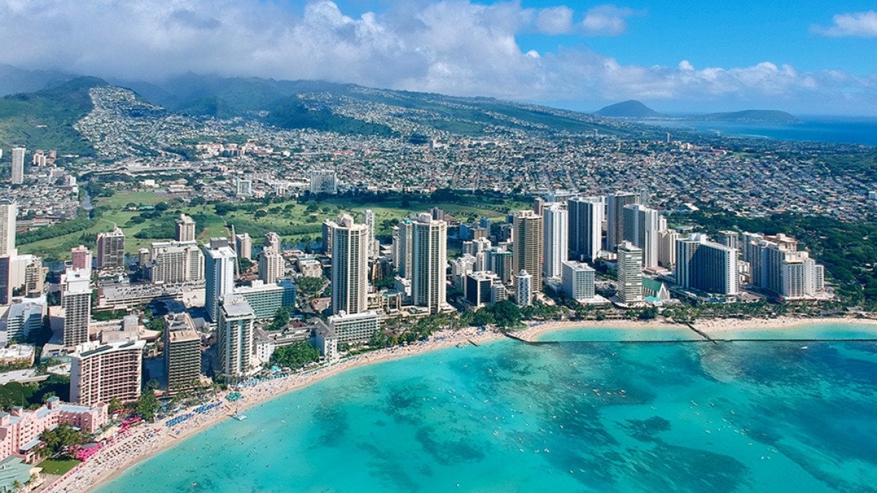 An aerial photo of Honolulu, Hawaii's coast and skyline.