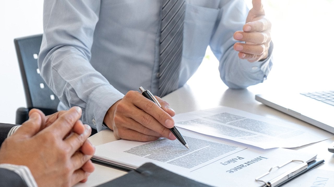 An insurance agent explaining a policy to a customer.