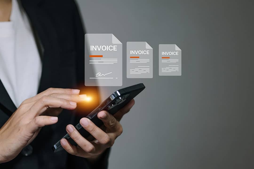 A business manager signing digital invoice documents from her smartphone.