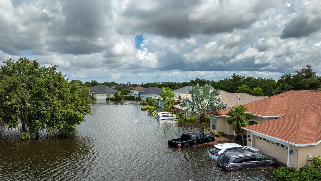 Homes, cars, and roads submerged in floods from a recent typhoon that affected the area.