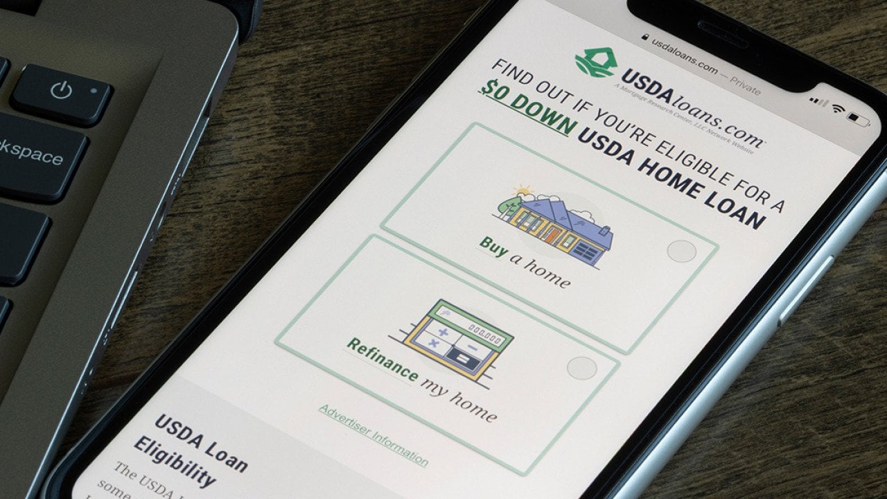 The homepage of the USDA loan program website on a smartphone.