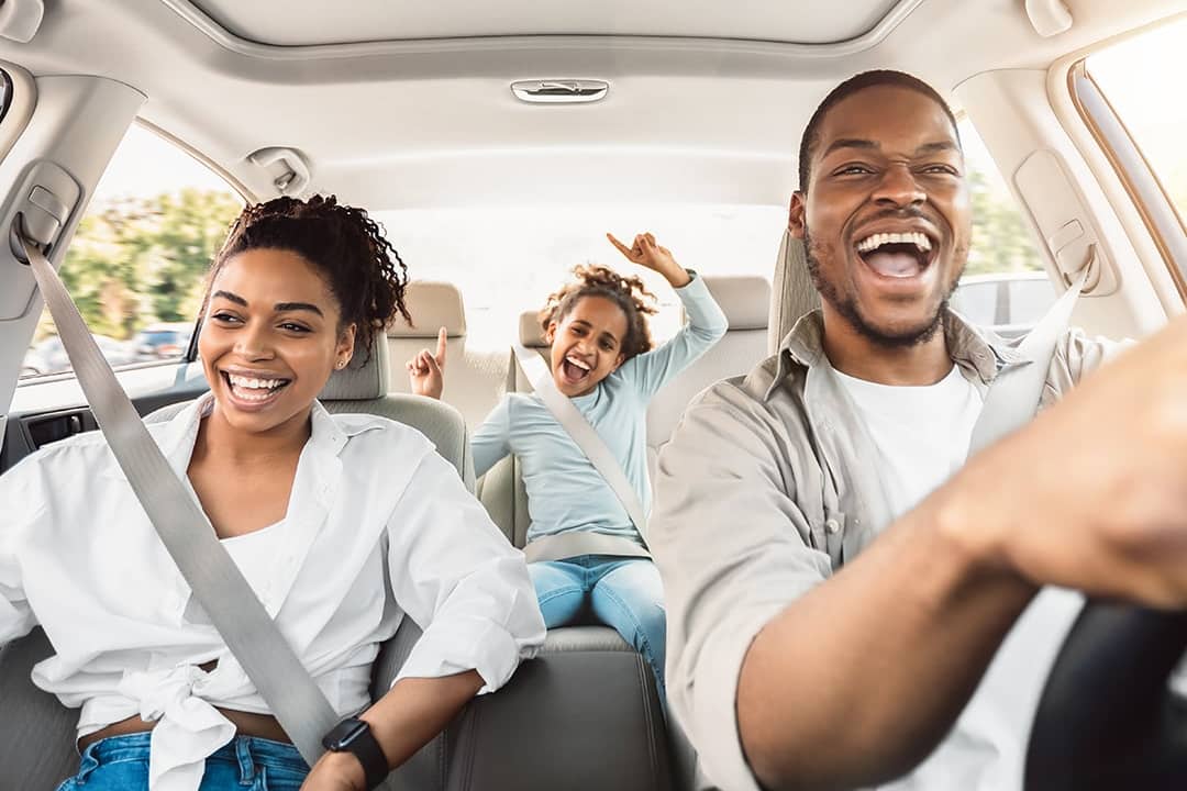 A happy family enjoying a summer road trip.