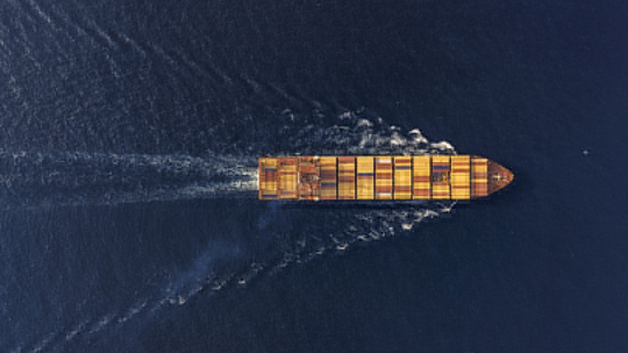 Aerial view of a large cargo ship traveling at sea.