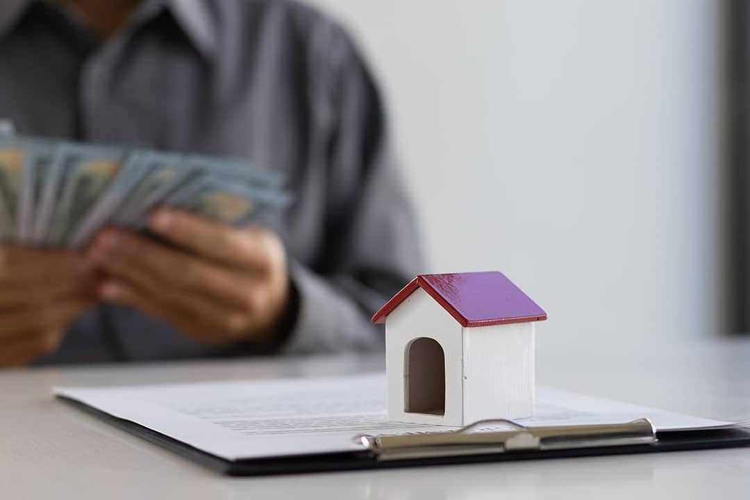 A real estate agent counting cash payment after closing a deal.