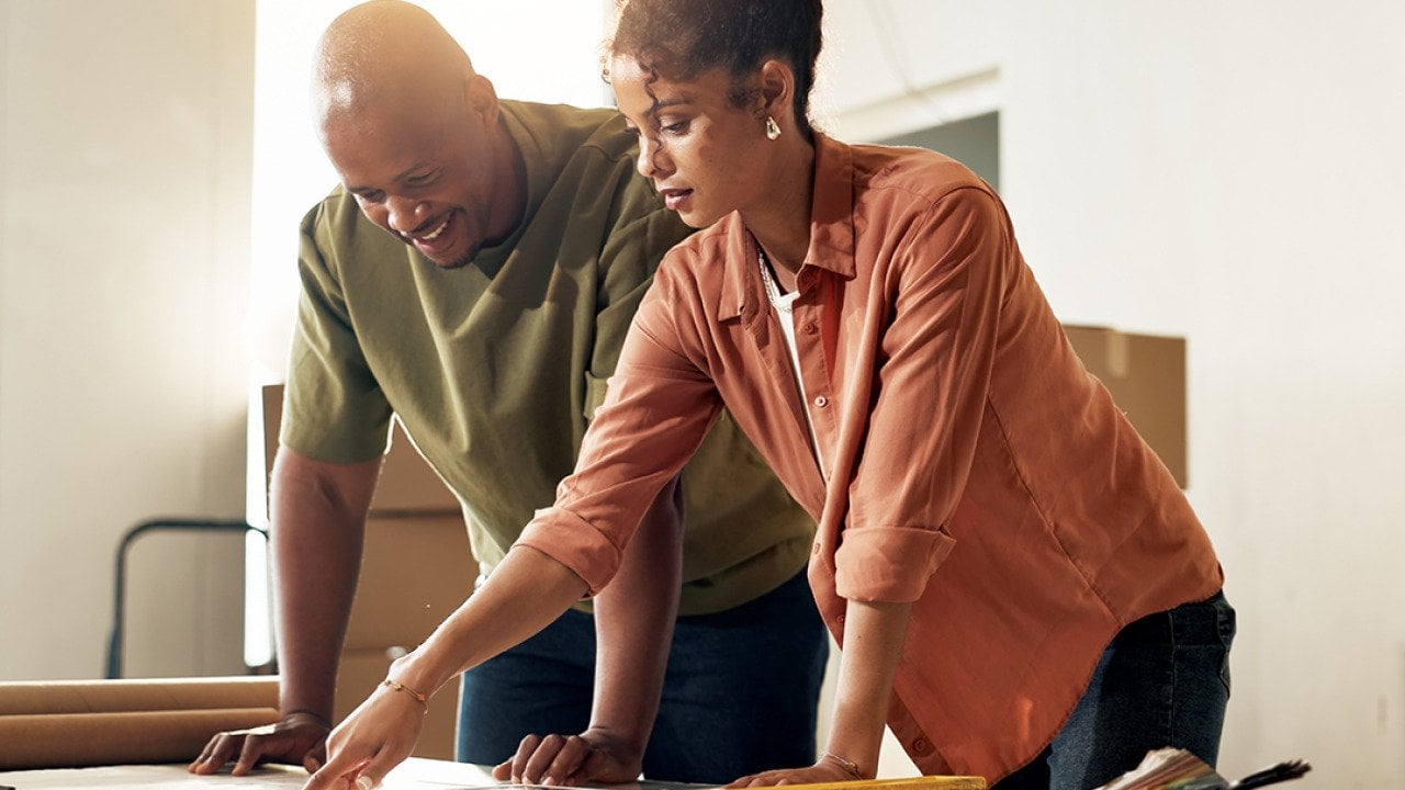 A couple reviewing renovation plans for their home.