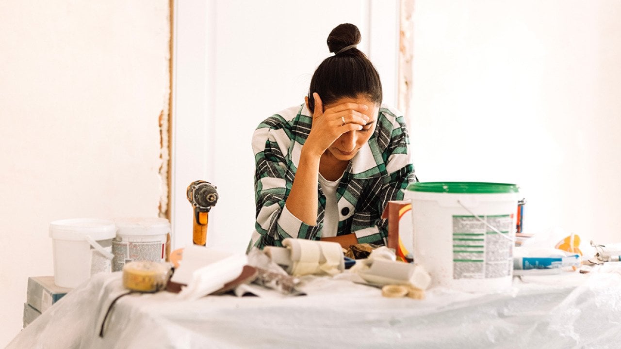 A young adult appearing to be tired from doing house painting and repairs.
