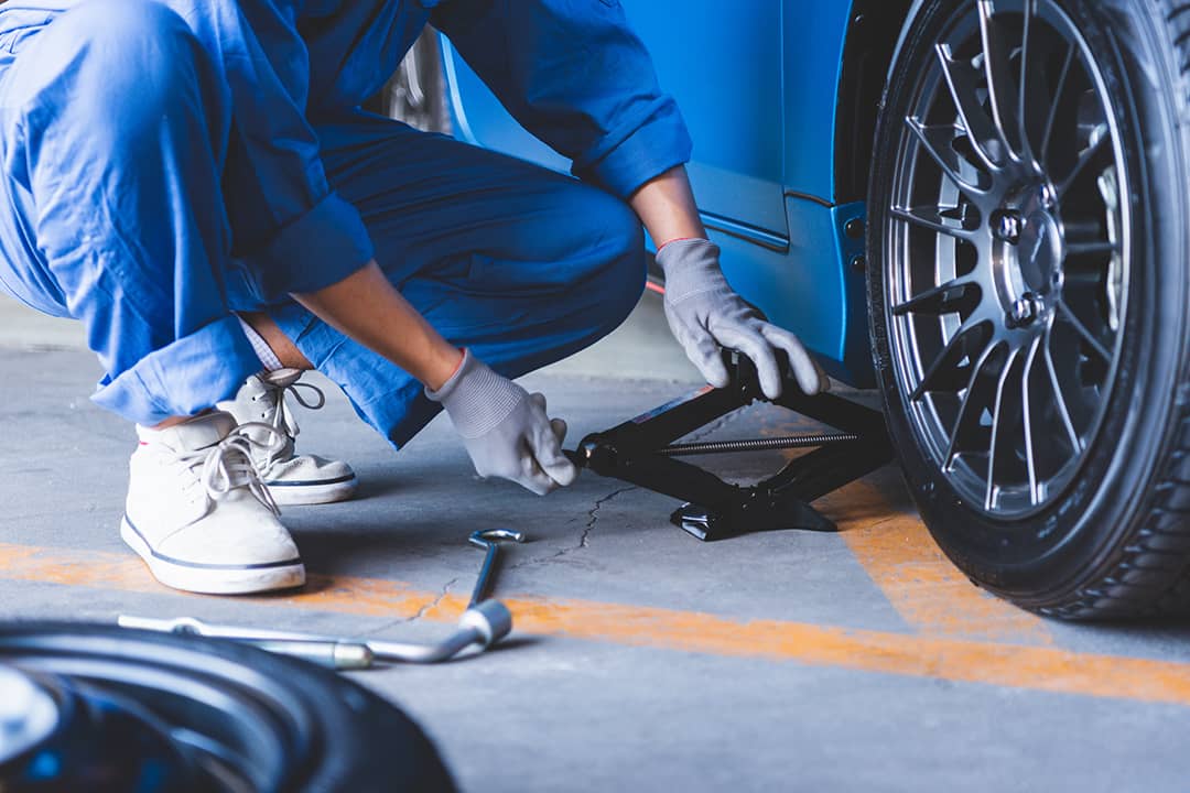 A car mechanic changing tires.