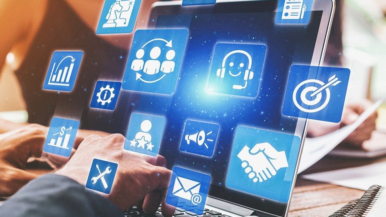 A business analyst managing CRM platforms from a laptop to improve customer relationships through data analysis.
