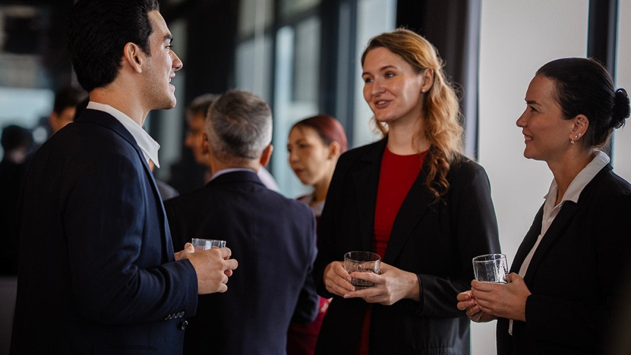 Colleagues engaged in a discussion during a party at work.