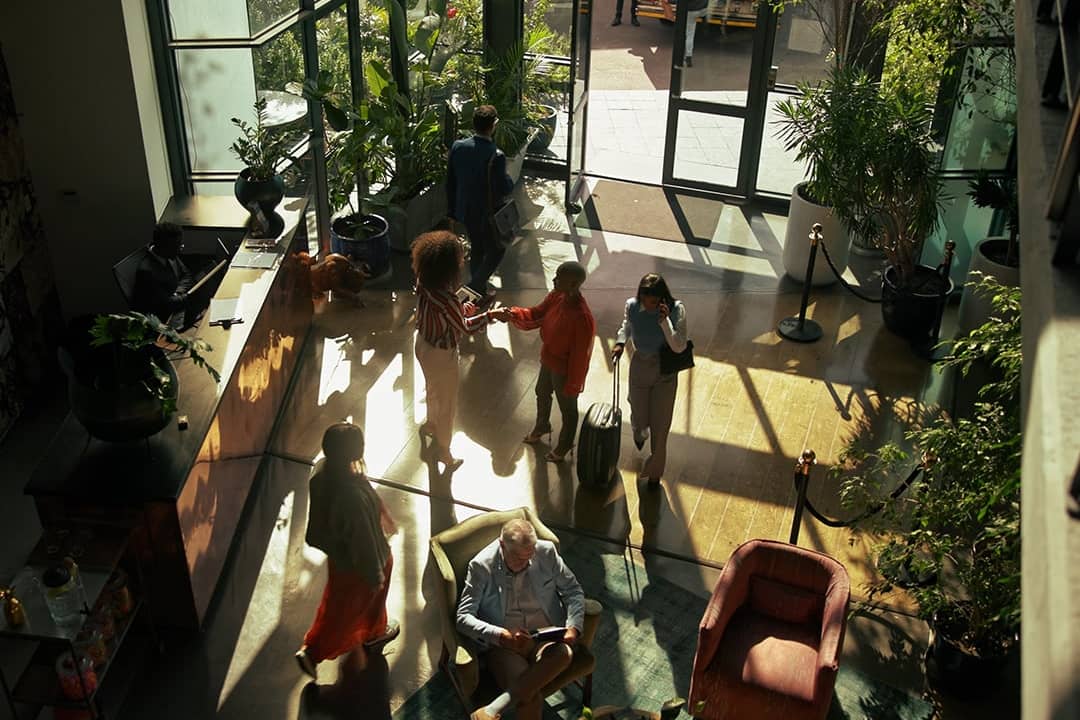 Guests arriving to check in at a hotel lobby.
