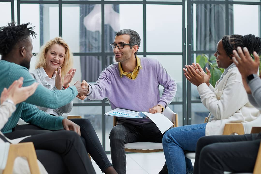 A diverse business team huddling in an office.