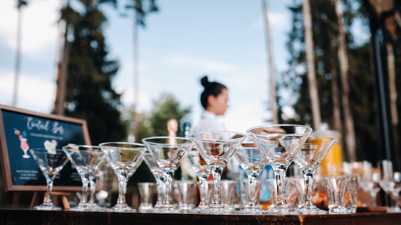 Empty martini glasses on an open bar.