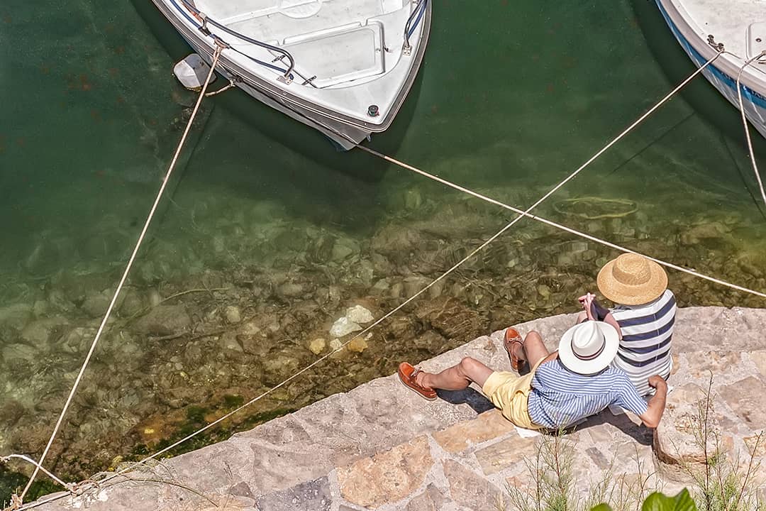 A senior couple relaxing by the lagoon.