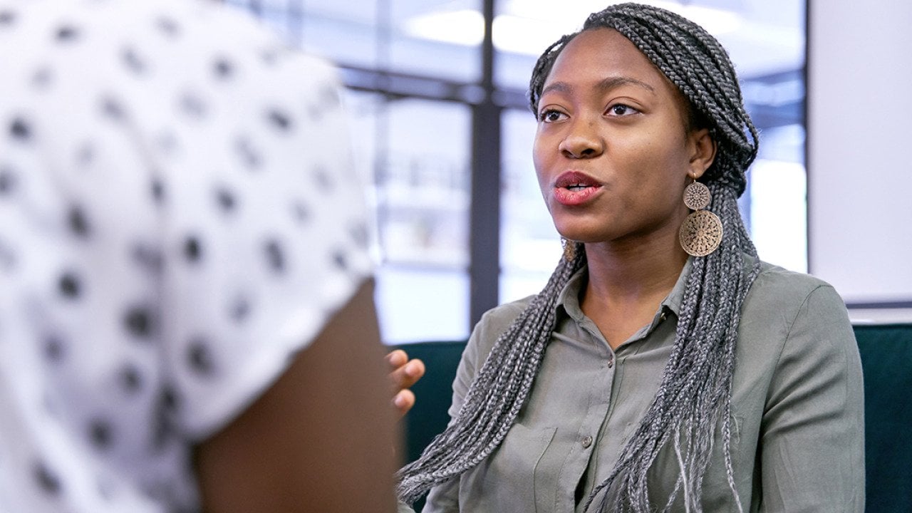 A businesswoman explaining information to a colleague.