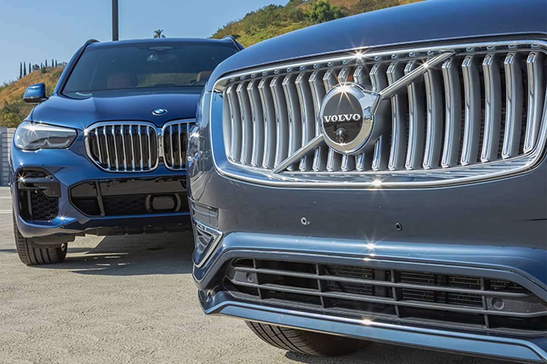 BMW X5 and Volvo XC90 cars parked together.