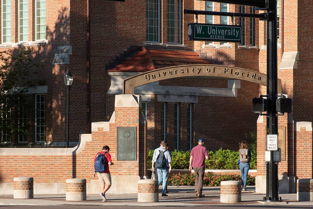 Students walking through an entrance gate at the University of Florida.