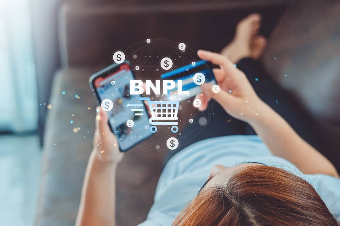 Woman shopping online illustrated with Buy Now Pay Later graphics.