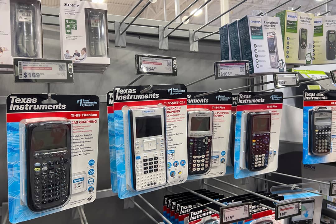 Graphing calculators displayed for sale inside an electronics store.