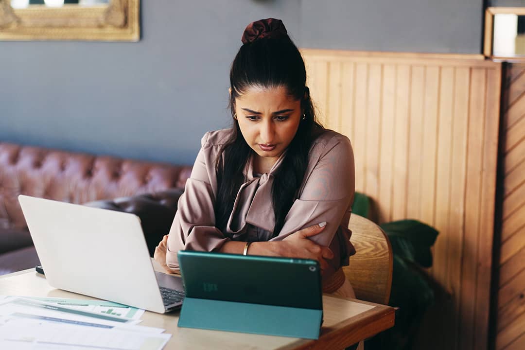 A businesswoman carefully reviewing work reports.