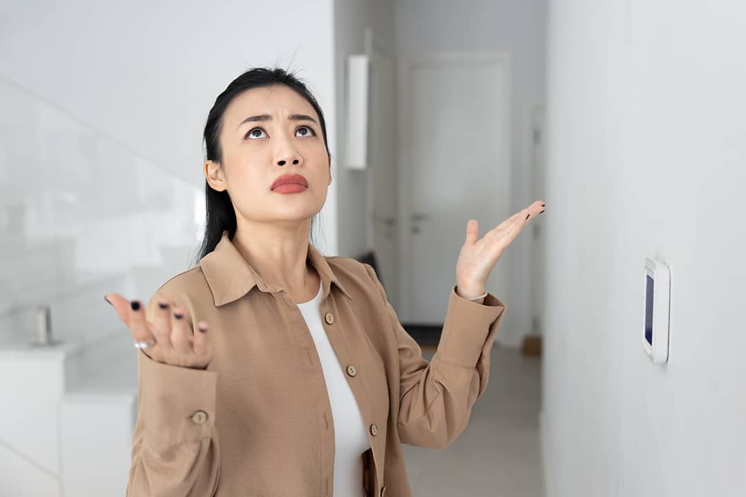 A confused female homeowner about air conditioning.
