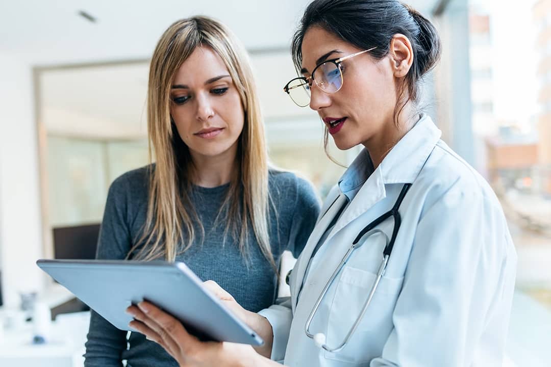 A female doctor helping her patient with consultation results.