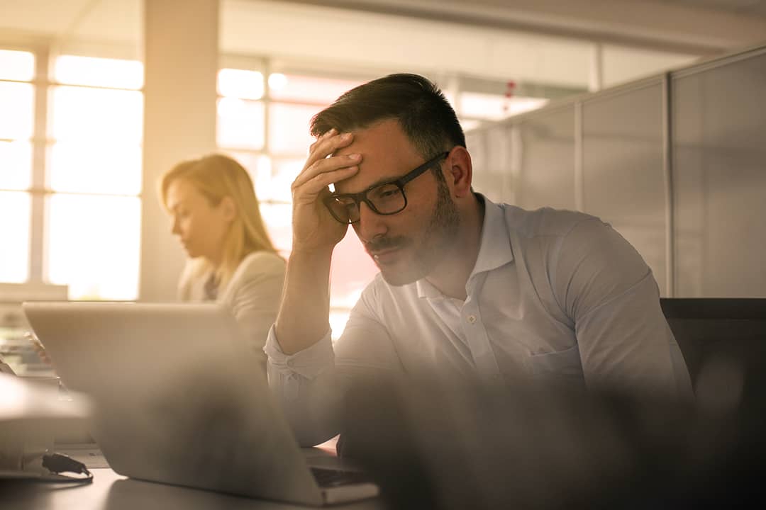 A stressed businessman at work.