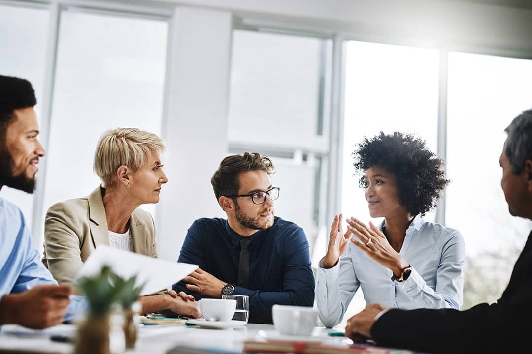 Business managers discussing the future of talent in their workplace from a meeting room.