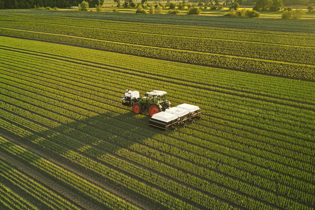 Aerial view of Ecorobotix machine working in a green field.