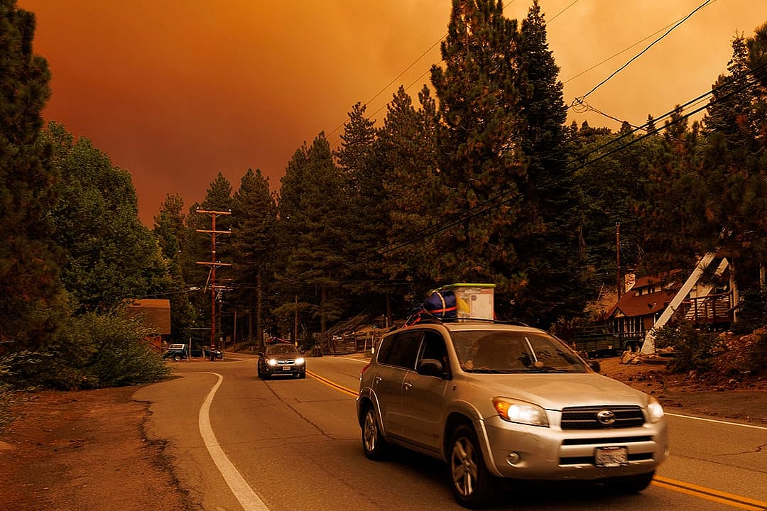 Cars driving away from the Line wildfire in Green Valley Lake, California, USA in September 2024.