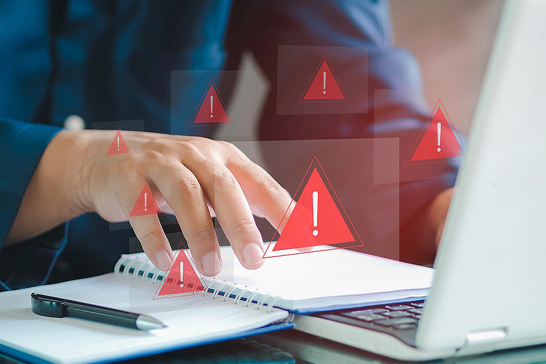 An employee receiving security alerts from a fraud attack on his laptop's network.