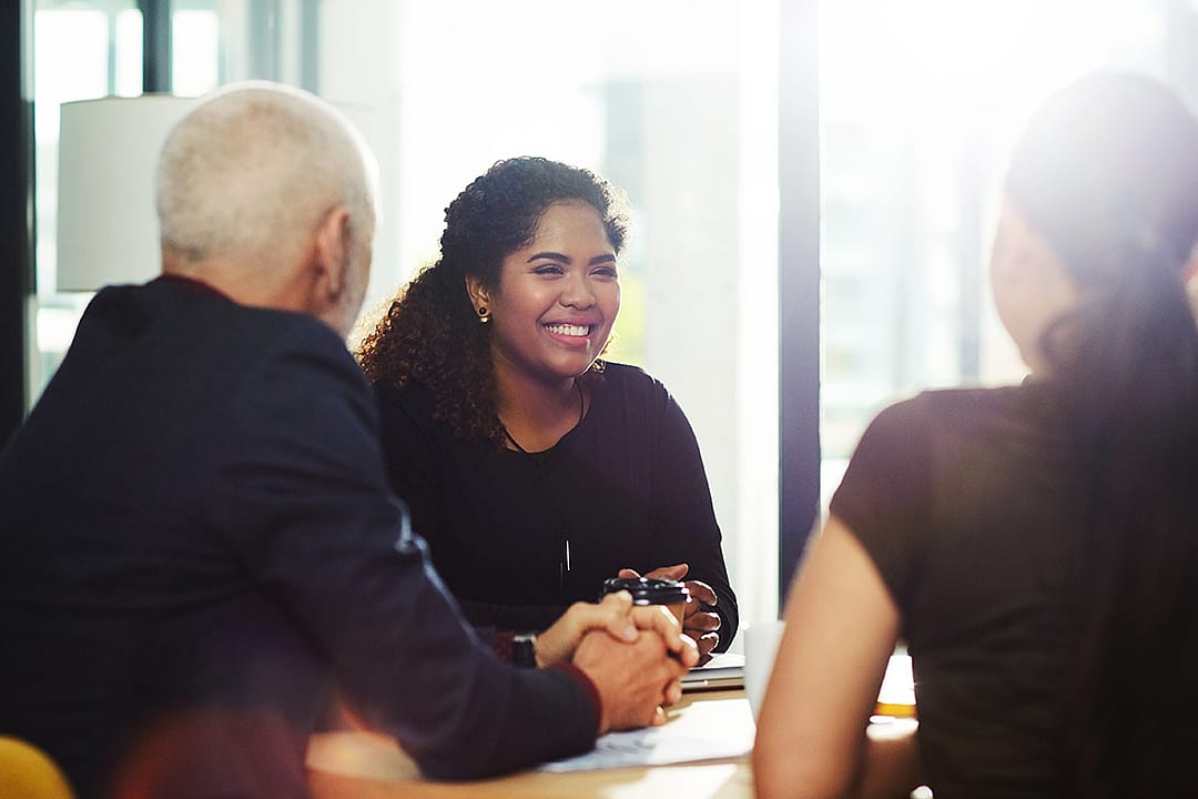 A group of professionals having a positive discussion during a meeting.
