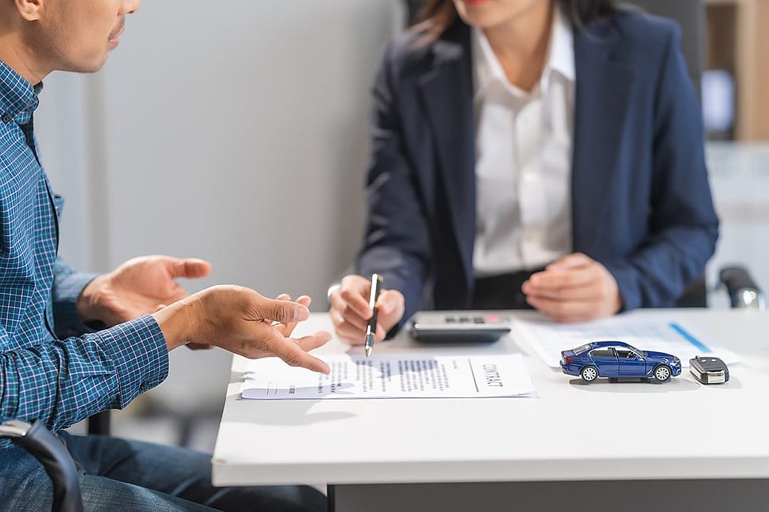 A loan professional guiding a client on a contract.