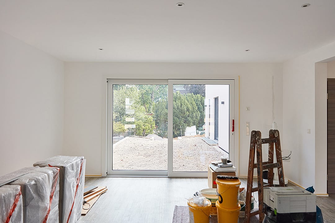 A spacious room overlooking a balcony during a general renovation and finishing.
