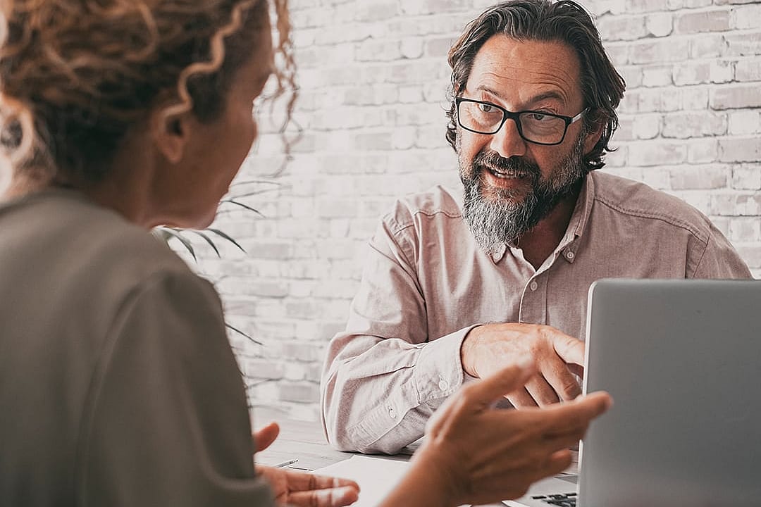 A consultancy professional engaged in discussion with a client.