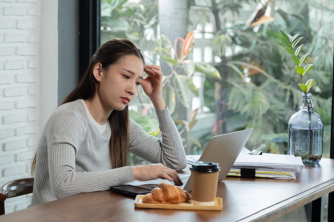 A female small business owner anxious in reviewing documents.