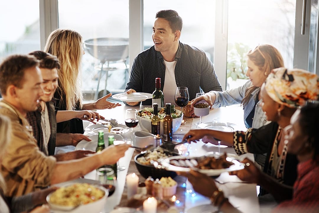A group of friends sharing a feast together indoors.