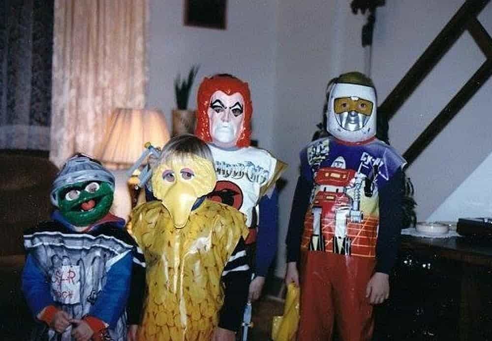 Four kids in halloween costumes from Kmart