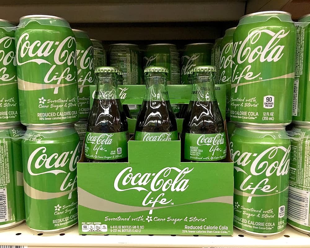 Cans and bottles of Coca-cola Life, a lower-calorie version of Coca-Cola, using stevia and sugar as sweeteners.
