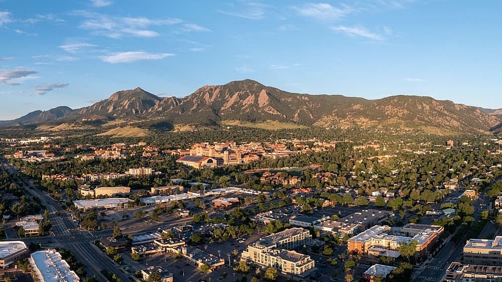 Morning sunrise photo of Boulder, Colorado  Highlights the city with a contrast on the mountains 