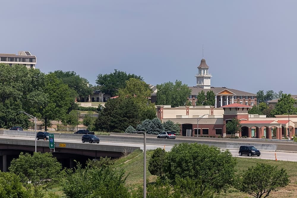 Overland Park, Kansas, USA - June 17, 2023: Morning traffic passes through the downtown commercial district of Overland Park.