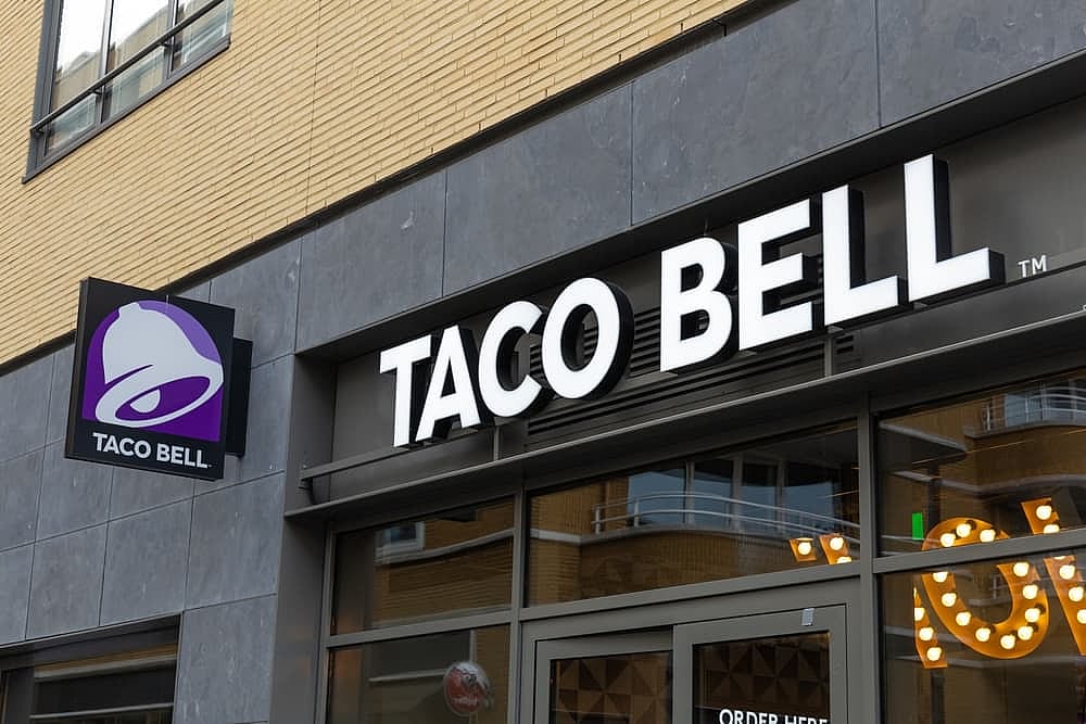 Taco Bell logo sign at the restaurant. Taco Bell is an American fast food chain.