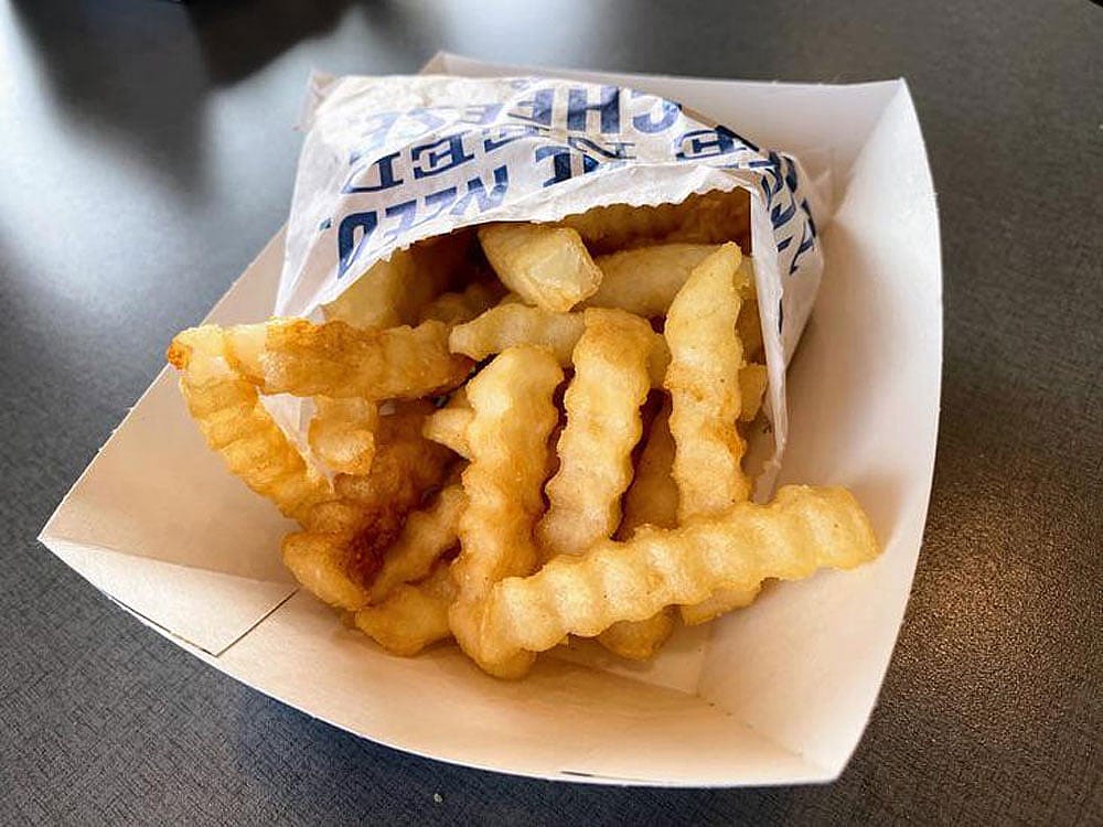 An order of Culver's crinkle cut fries in a paper basket
