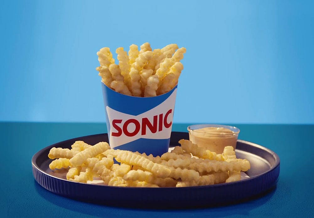 Promo photo of Sonic groovy fries on a blue plate