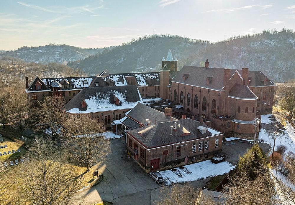 Aerial view of Mt. Alvernia, with snow visible on rooftops and on pavement.