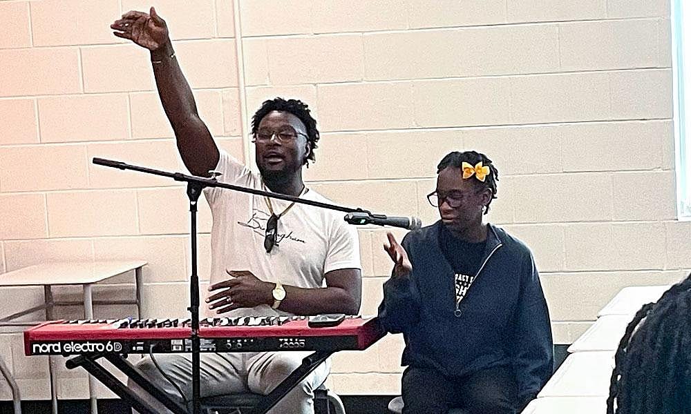 Legacy Prep student Malaysia Speight sang with local recording artist Jarvis Halsey during the school’s “Lights, Camera, Action” summer program.