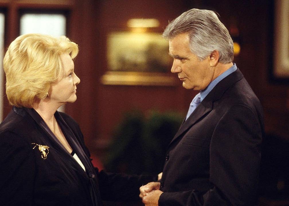 A man and woman stare seriously at each other.